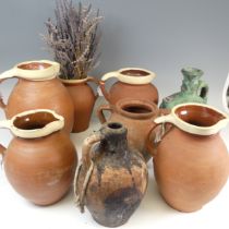 A matched set of four graduated pottery Jugs, with cream glazed rims, the tallest H 29cm, together