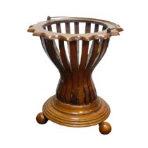 An Edwardian mahogany Regency inspired Planter, with slatted circular base, raised on four rounded