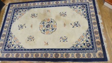 Hand-knotted Rugs; an old Chinese cream ground carpet, the centre with floral sprays and butterflies