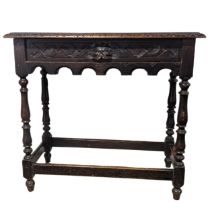 An antique 18th century style oak side Table, rectangular plank top above carved green man drawer,