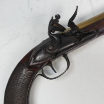 An early 19th century brass barrel flintlock Pistol, 5 1/2 inch barrel, steel lock plate with scroll