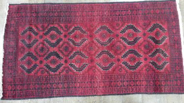 Tribal Rugs; a red ground Afghan rug, wool pile on cotton base, 179cm x 94.5cm, good overall