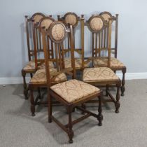 A Set of Six Arts and Crafts oak Dining Chairs, the top rails with upholstered headrests, stick back