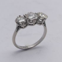 A three stone diamond Ring, the centre stone approx. 0.8ct, with a smaller stone on either side, one