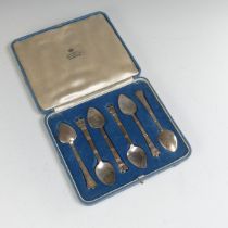 R.E.Stone; A cased set of six silver Teaspoons, hallmarked London 1935, the finials modelled as