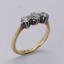 A three stone diamond Ring, the centre stone approx. 0.21ct, with a smaller stone on either side,