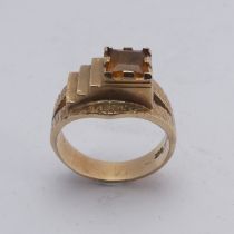 A 1970's style 9ct gold and citrine Ring, the square facetted stone in offset textured mount with