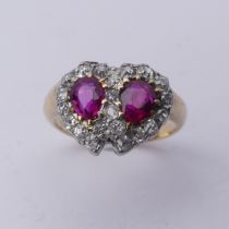 A late Victorian ruby and diamond cluster Ring, formed as two entwined hearts, central pear shaped