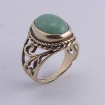 A jade Dress Ring, the oval cabochon stone approx. 13mm long, collet set in ropetwist mount with