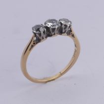 A three stone diamond Ring, the old cut stones claw set in 18ct yellow gold and platinum, approx.