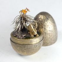 Stuart Devlin; A silver gilt 'Surprise Egg', hallmarked London 1981, the textured egg opening to