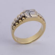 An 18ct yellow and white gold Ring, the squared front set with a small diamond point, with stepped