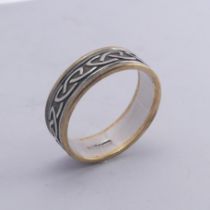 An Irish two colour 10ct gold Band, with Celtic decoration, Size Y, 8.4g.