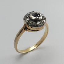 A diamond cluster Ring, the single cut stones in a circular white metal mount with an 18ct yellow