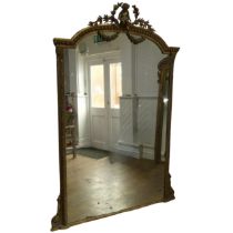 A 19th century large gilt framed wall Mirror, central pediment depicting a carved Putti, scrolled