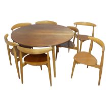 Hans Wegner for Fritz Hansen ; A Danish teak and beech dining Table with seven 'heart' Chairs, the