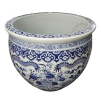 A large decorative antique Chinese blue and white Jardiniere, decorated with dragons amongst