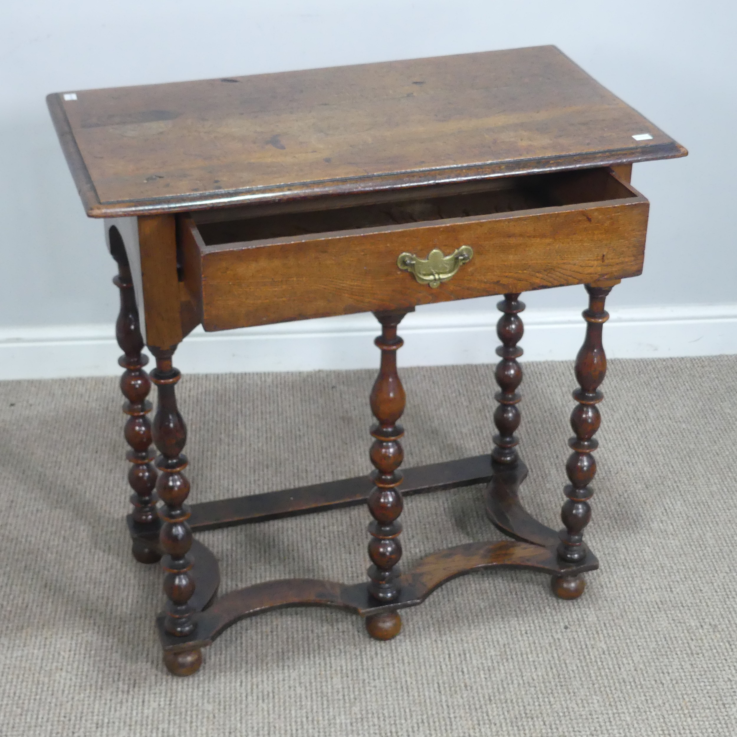 An antique Queen Anne style oak side Table, rectangular overhanging moulded top above singular