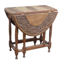 An Anglo-Chinese style drop-leaf gate-leg Table, oval top with carved foliate border and central