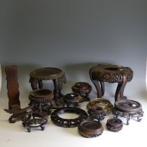 A large quantity of antique and later Chinese hardwood Stands, of varying sizes, shapes and