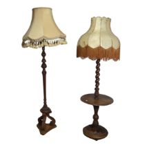 An early 20th century mahogany standard Lamp, with reeded and foliate carved column raised on tripod