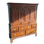 A Georgian oak Housekeepers Cupboard, with moulded cornice over two panelled doors, above base