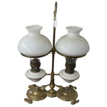 A Victorian student's desk double Oil Lamp, with opaque glass shades above ceramic reservoirs,