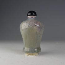 A Chinese flambé porcelain Snuff Bottle, the glaze of blues and greys, raised on foot, H 7cm