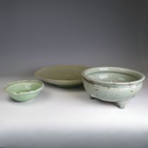 A large antique Chinese celadon Charger, hairline cracks and firing fault to the foot, D 32cm,