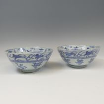 A pair of antique Chinese blue and white Bowls, with underglaze bandes of decoration, raised on