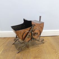 An Arts and Crafts copper Coal Scuttle, in the manner of Christopher Dresser, with swing handle