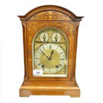 A London Camerer Kuss & Co marquetry inlaid mantel Clock, the arched brass dial with foliate