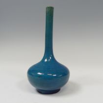 A slender 19thC Chinese monochrome Vase, of blue coloration and globular bottle shape, raised on