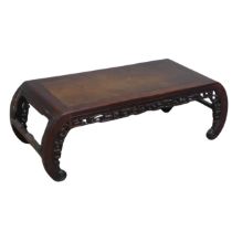 A Chinese carved hardwood opium / coffee Table, top set with rectangular panel, above scrolled and