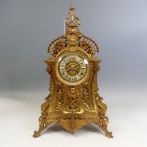 A large antique French ormolu style gilt metal Mantel Clock, enameled Roman numeral dial, encased in