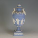 A Wedgwood Jasperware twin-handled Urn, with 'Dancing Hours' decoration and Bacchus mask handles,