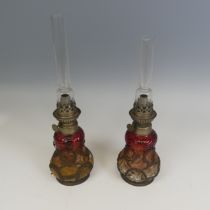 A pair of unusual Wild & Wessel cranberry glass oil Lamps, Berlin, marked 'W & W / Kosmos',