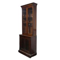 A Victorian mahogany glazed Bookcase of narrow proportions, moulded cornice above two glazed
