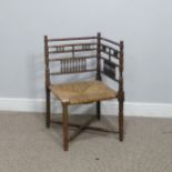 A 19th century sussex-style bobbin turned corner Chair, with rush seat, W 41 cm x H 68 cm x D 42 cm.