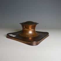 An Arts and Crafts copper Inkwell manufactured by Rathbone, of Capstan form, base stamped '