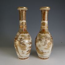 A pair of early 20thC Japanese satsuma Vases, of elongated bottle form, decorated in typical