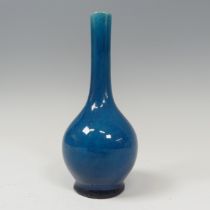 An antique Chinese monochrome Bottle Vase, of blue colour, on potted foot, firing faults to foot,