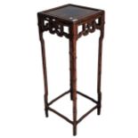 An antique Chinese hardwood Plant Stand, square top above carved foliate frieze, raised on bamboo