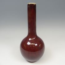 A Chinese sang de beouf flambe Bottle Vase, with globular body and slender tapering neck, H 31.5cm.