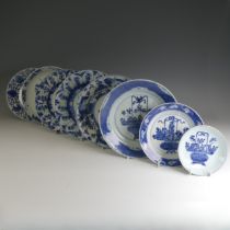 A near pair of early 18thC Chinese porcelain blue and white Plates, the well decorated with flower