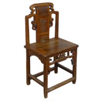 A 20th century carved Chinese hall Chair, scrollwork back with centre panel carved with figure and