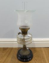 An antique clear glass and brass Oil Lamp, stamped 'English Made', with fluted frosted and etched