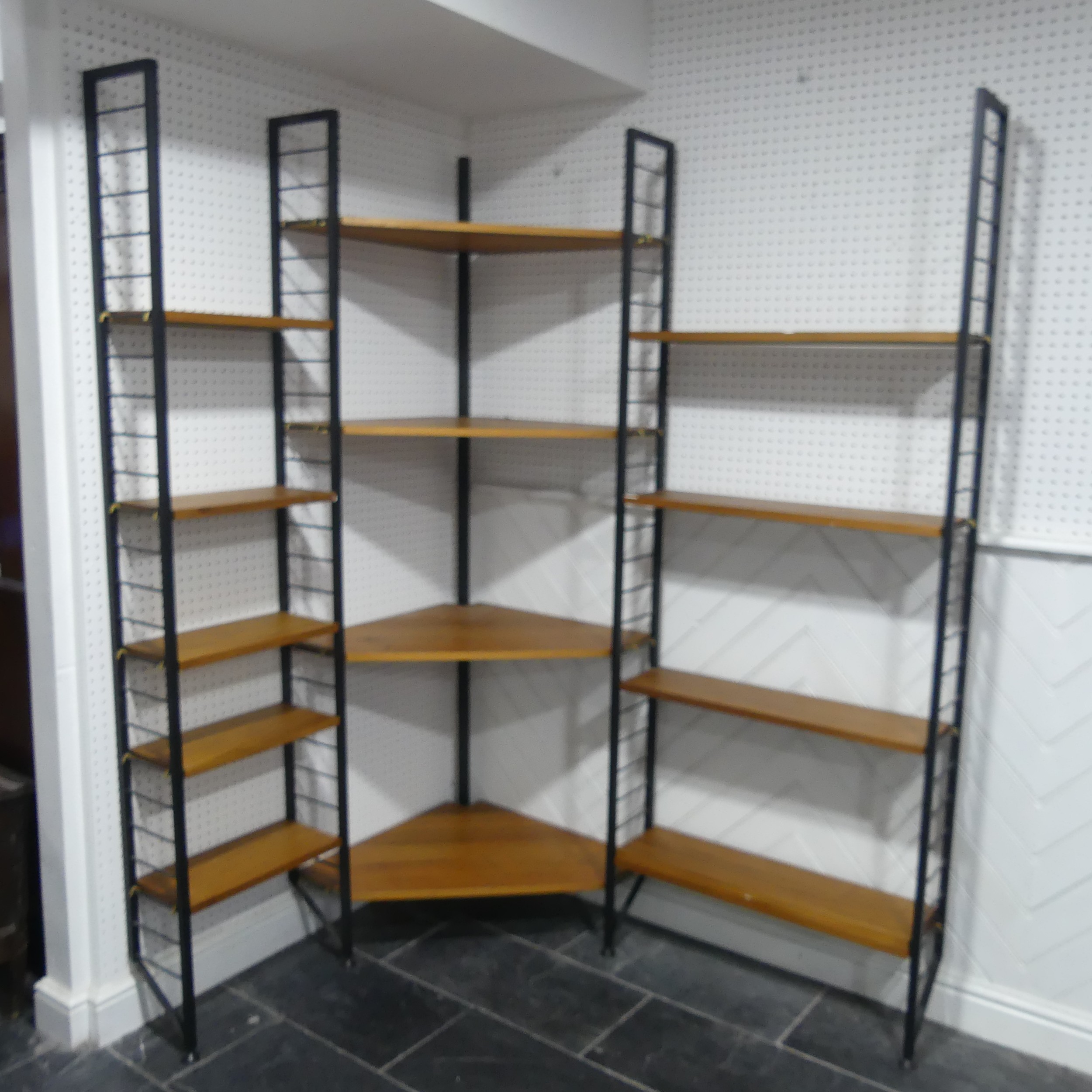 A mid 20th century teak Ladderax corner shelving System / Unit, comprising of four black metal