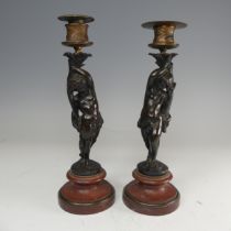 A pair of French probably 19th century gilt and bronze figural Candlesticks, each featuring a