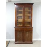 A Victorian mahogany glazed Bookcase, moulded cornice over glazed doors and three adjustable